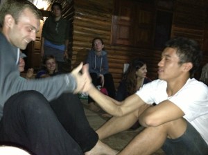Singto thumb wrestling with one of the other volunteers.